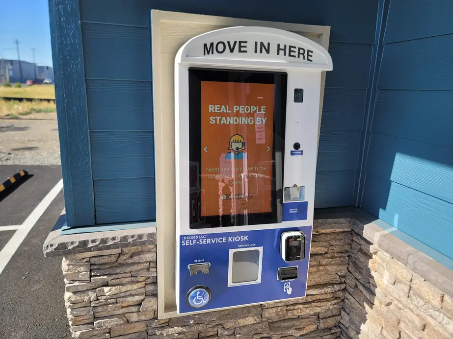 Self-service move-in kiosk set into a stone wall at The Heights Self Storage